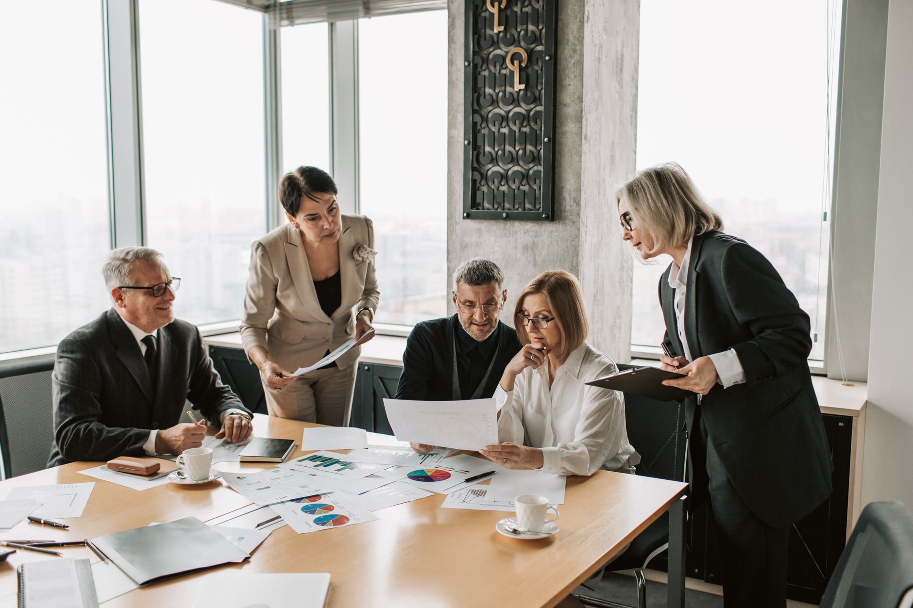 Professionals reviewing investment documents in a modern conference room
