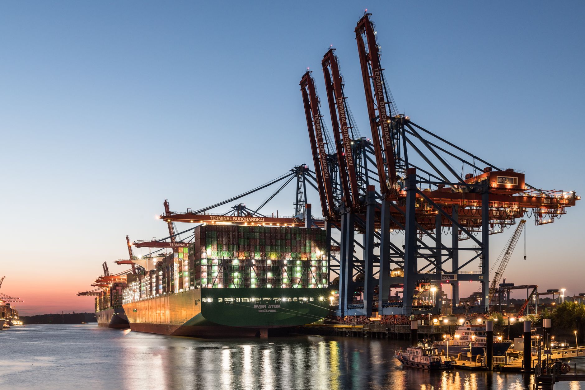 Rows of shipping containers stacked on a commercial port dock