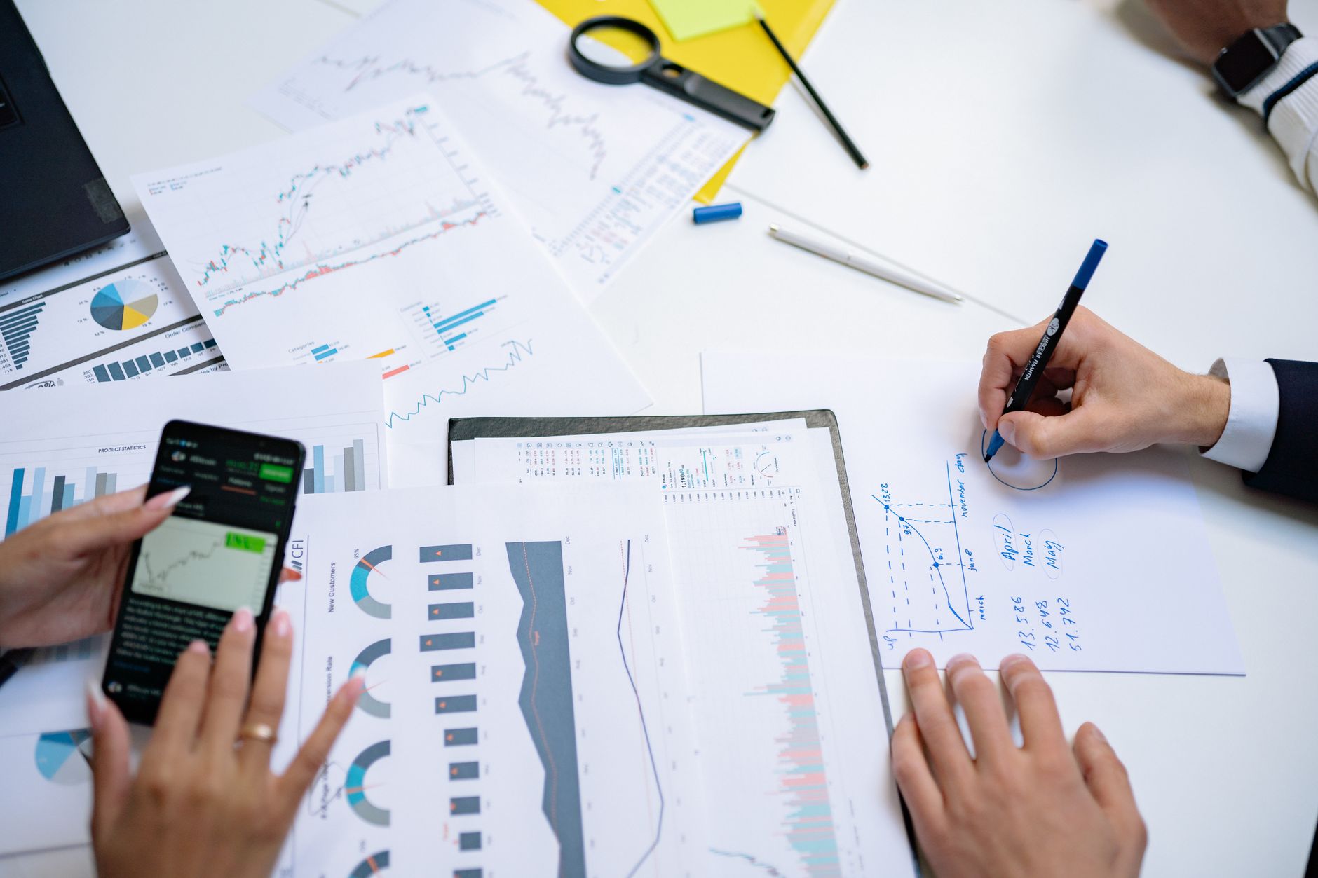 Business professionals reviewing financial documents in a formal meeting room