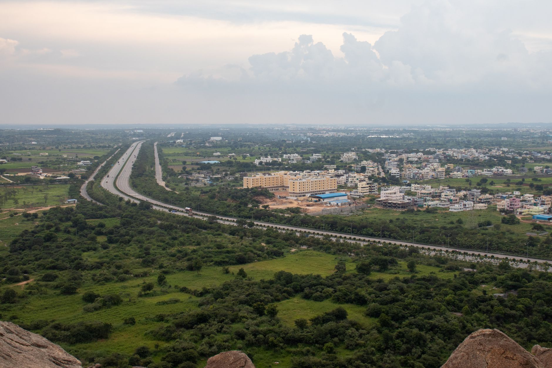 Open land adjacent to a major highway corridor at dusk