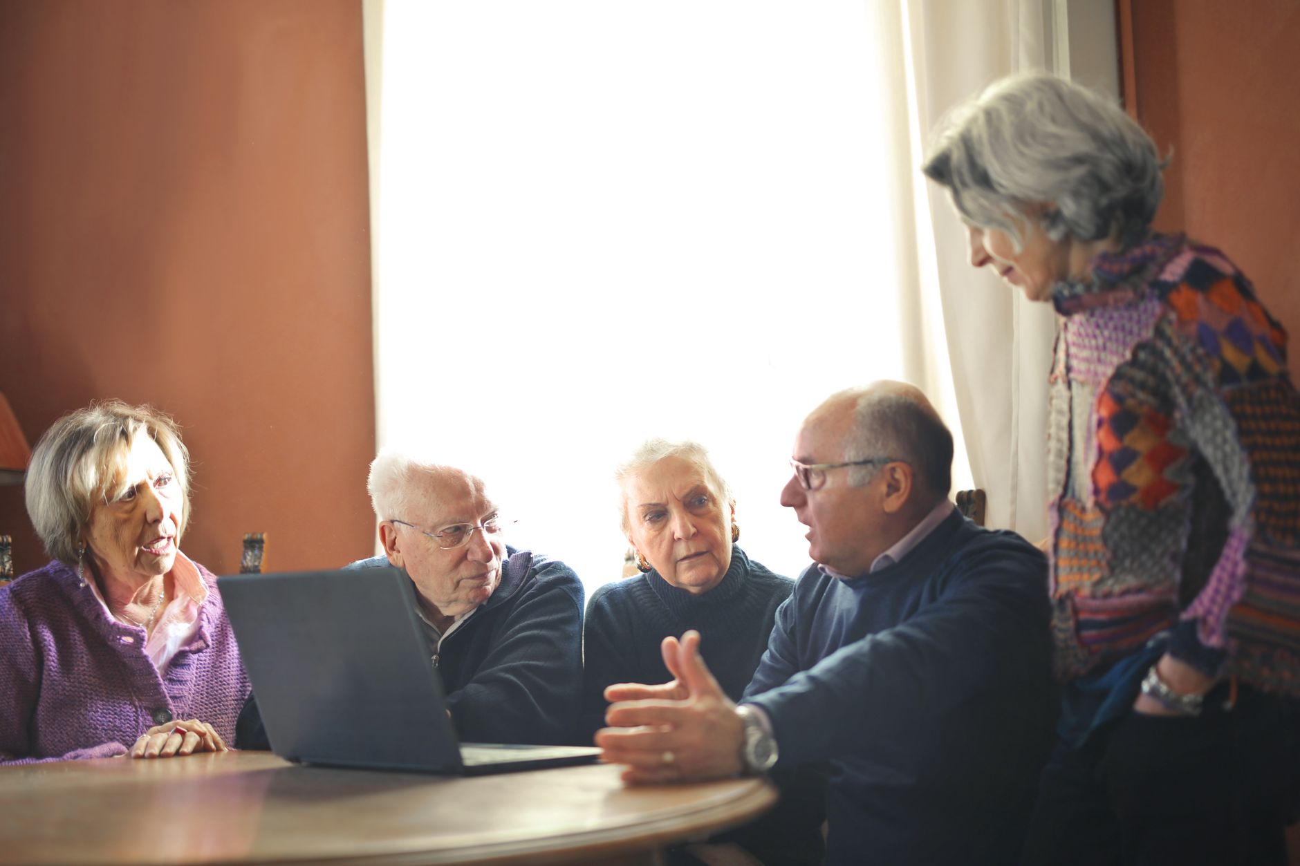 Investment committee professionals reviewing infrastructure portfolio documents at a conference table