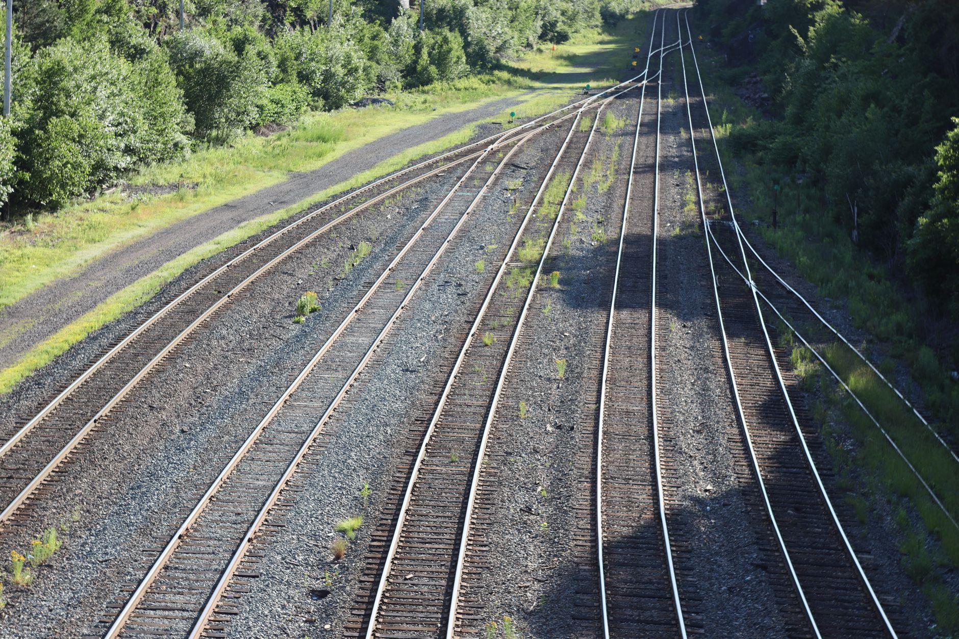 Aerial view of freight rail corridor cutting through industrial landscape
