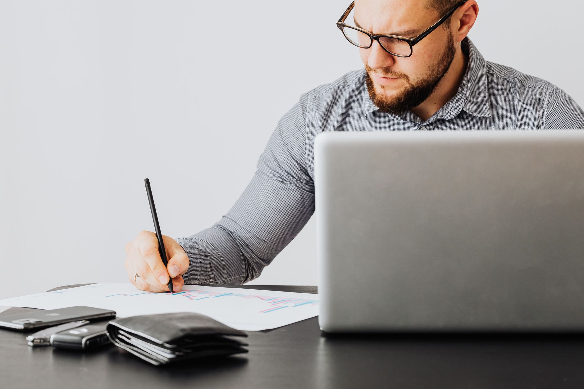 Financial documents and contract papers spread on a desk representing royalty agreement due diligence