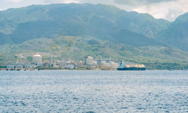 Large LNG regasification terminal facility at dusk with industrial infrastructure