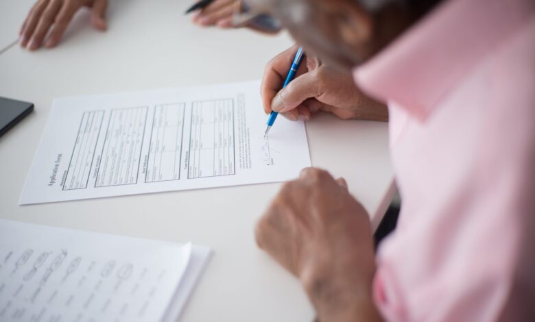 Business professionals reviewing insurance contract documents at a conference table