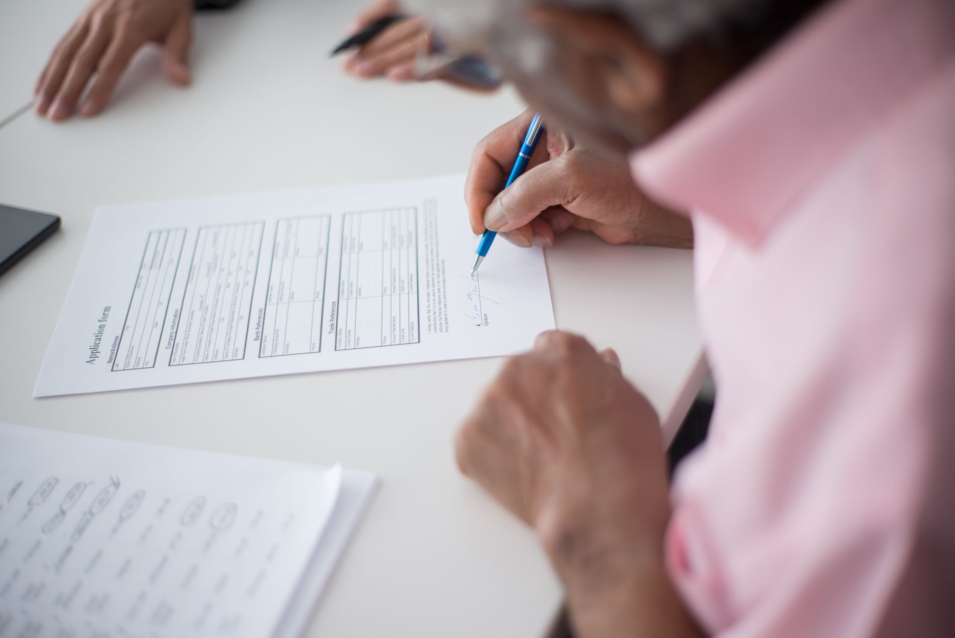 Business professionals reviewing insurance contract documents at a conference table