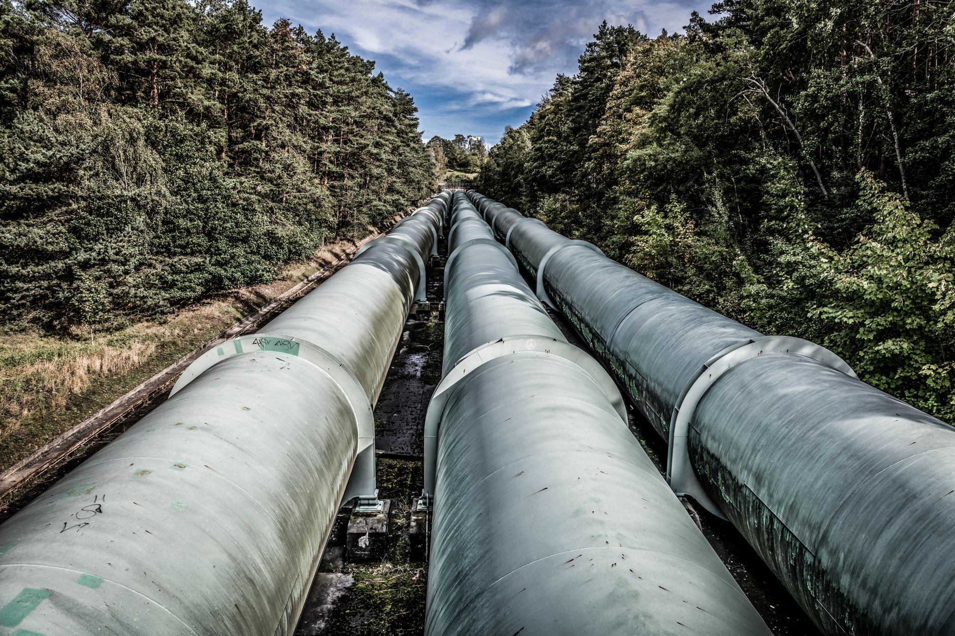 Oil field pipeline infrastructure in a dry desert landscape representing produced water handling systems