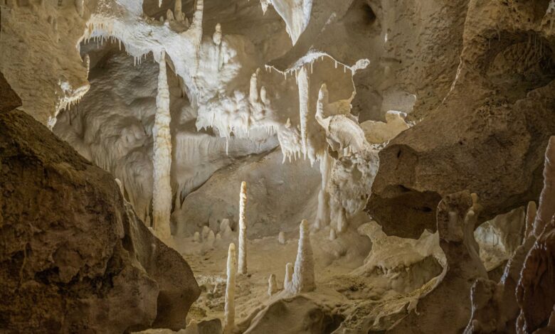 Interior view of a large underground industrial storage facility carved into rock