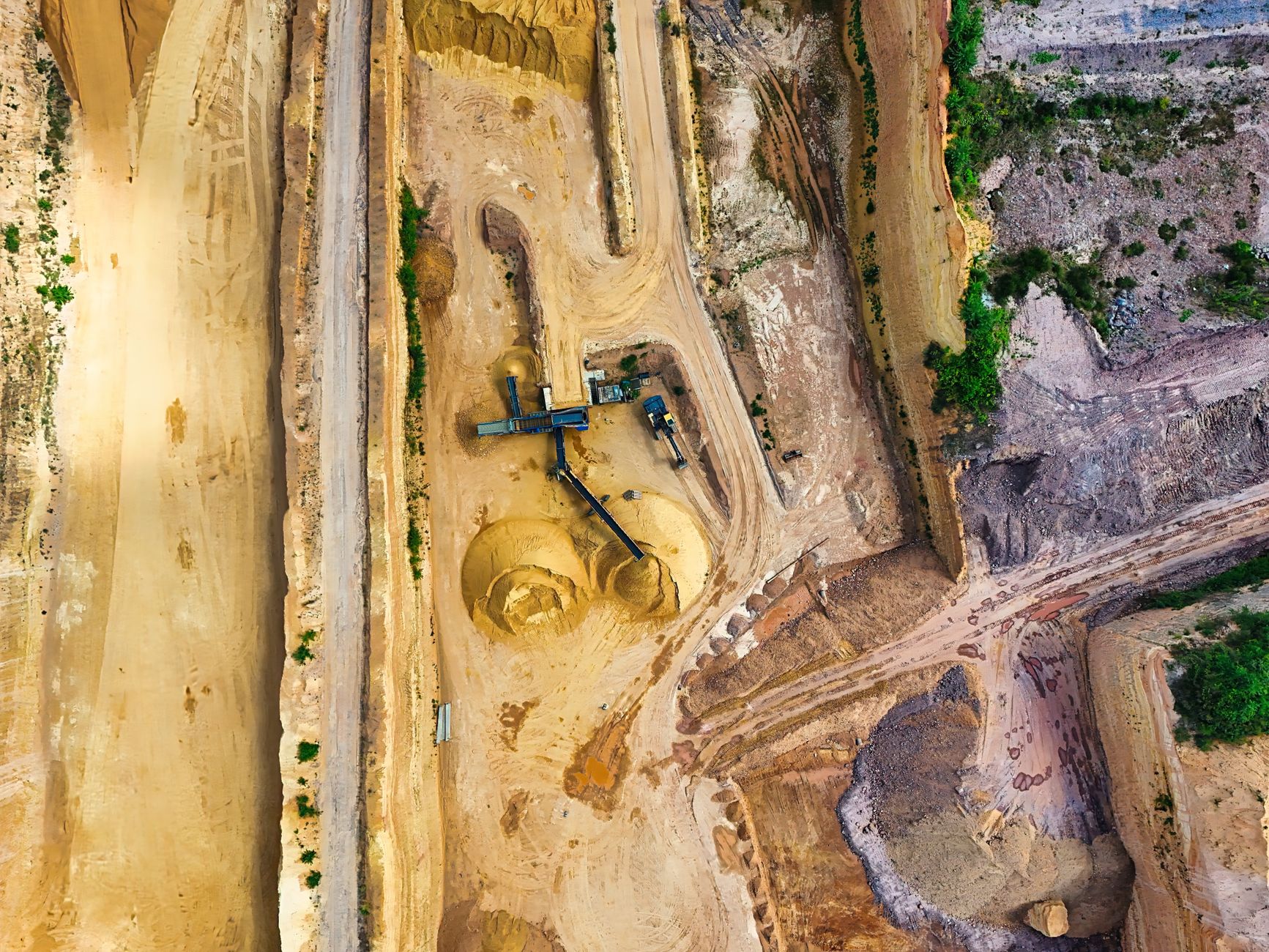 Aerial view of an open pit mining operation representing phosphate rock extraction