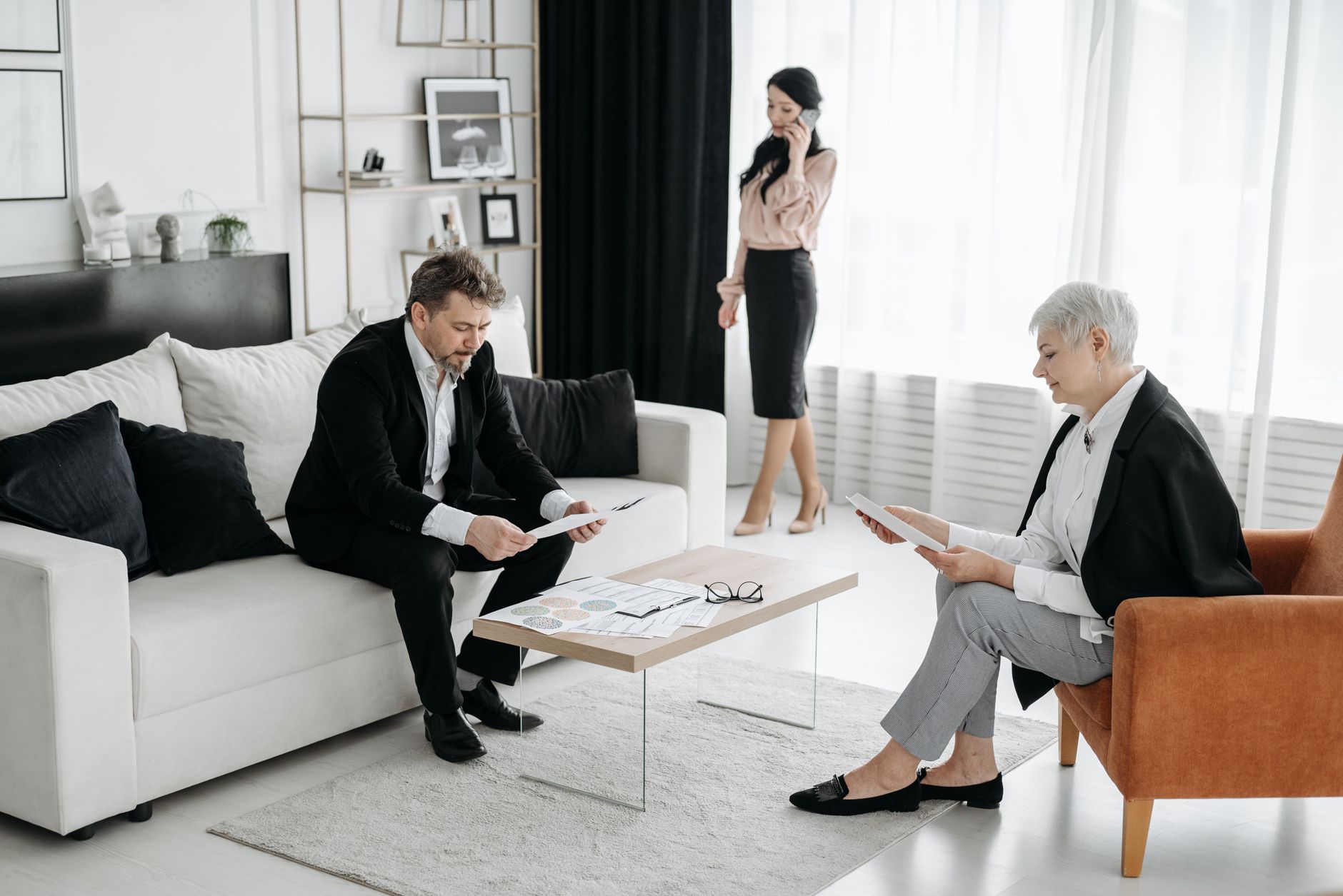 Wealth managers and family office advisors reviewing long-term investment portfolios in a conference room